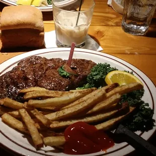 RIBEYE w FRIES and a White Russian.. complimentary bread loaf.