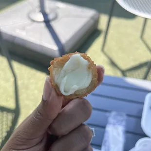 a hand holding a piece of food