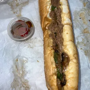 Cheesesteak with onions, peppers and mushrooms and a side of cherry peppers