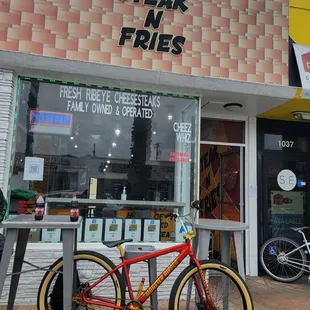 a bicycle parked in front of a restaurant