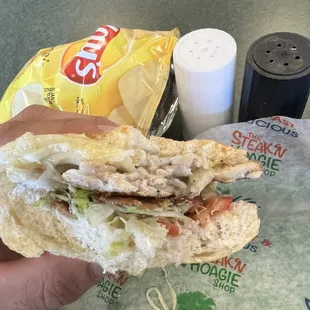 All lettuce and tomato and the thinnest slice of chicken