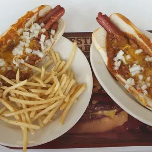Two feet of chili cheese dogs and some fries.