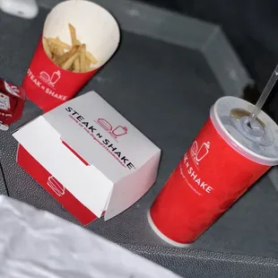  a tray with fries and a drink