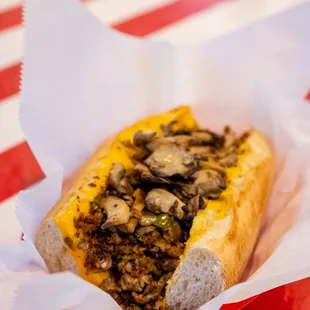 a hot dog with mushrooms and cheese