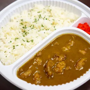 a plate of rice and a bowl of curry