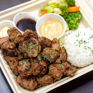 a tray of food with rice and broccoli