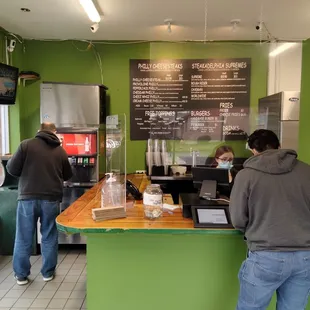 two men standing at a counter
