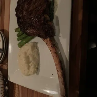 Tomahawk ribeye with mashed potatoes and asparagus