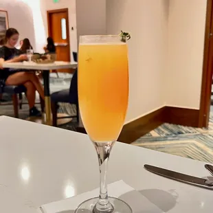 a glass of orange juice on a table