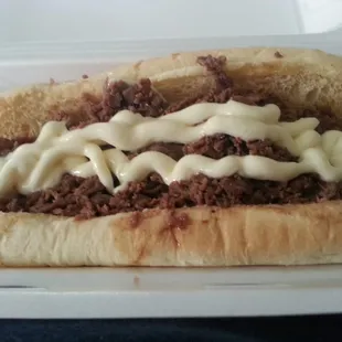 Steak sandwich with cheese and mayo.