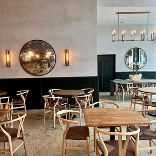 a dining area with round tables and chairs