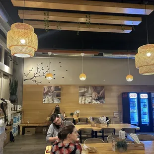 two people sitting at a table in a restaurant