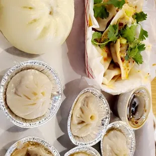 a tray of dumplings and a bowl of soup