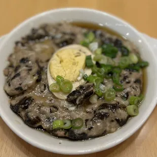 a bowl of mushroom soup with a hard boiled egg