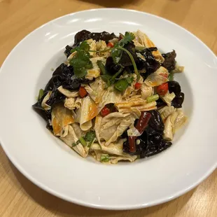 a plate of pasta with chicken and vegetables