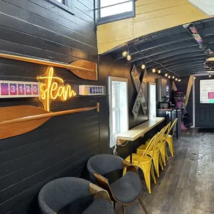 a row of chairs and a neon sign