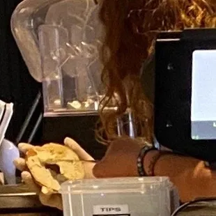 This pic shows the barista with his hair hanging over the bagel. Yuck.