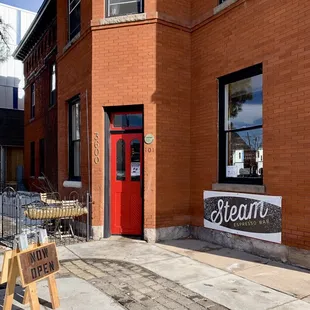 a red door and sidewalk