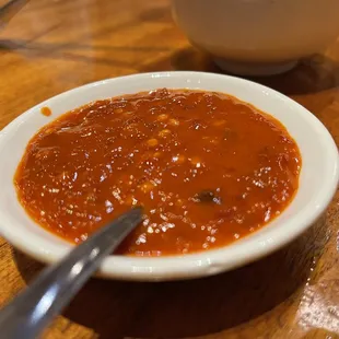 a bowl of soup on a wooden table