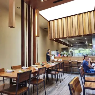 a dining area with wooden tables and chairs
