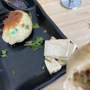 Tofu being stacked on other plate