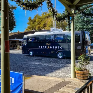 a tour bus parked at a station