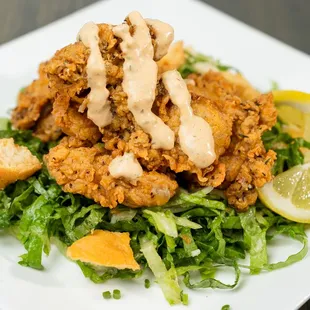 a plate of fried chicken and greens