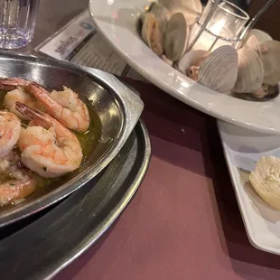 Steamed clam with essential of edible type, oil (butter) alongside Shrimp Scampi