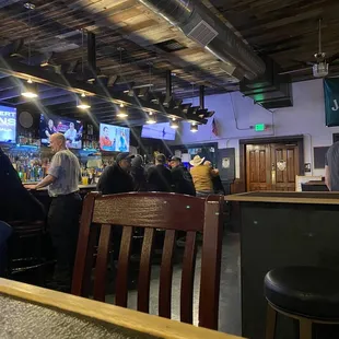 a group of people sitting at a bar
