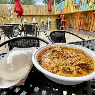 Egusi with Goat Meat and Fufu at their back patio