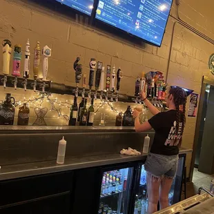 a woman pouring a drink