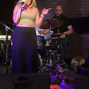 a woman singing on stage