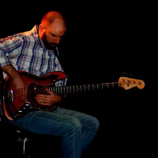 a man playing a bass guitar