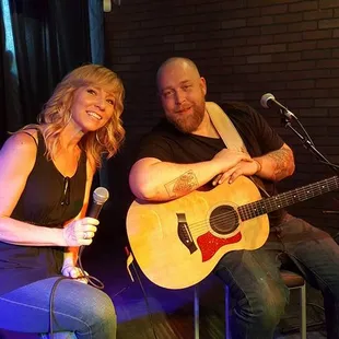 a man and a woman playing guitar