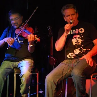 a man playing violin and a man singing