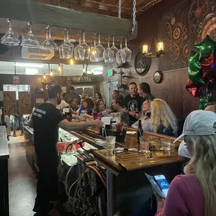 a group of people sitting at a bar