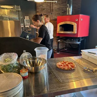 Our team working hard at providing fresh wood fired pizzas