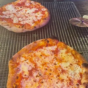 two pizzas on a grill