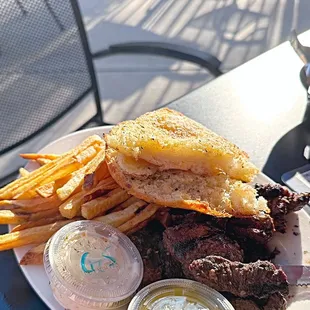 Steak dinner with fries and garlic bread