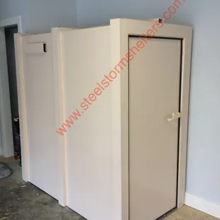 SafeRoom Storm Shelter by Steel Storm Shelters LLC in a existing garage.