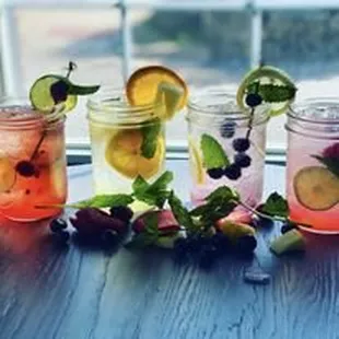 a variety of drinks in mason jars