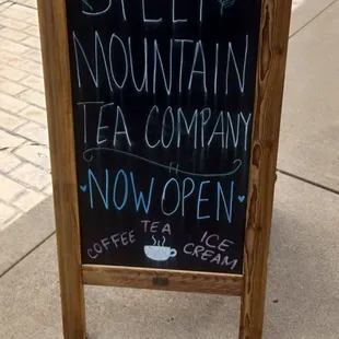 a sign on a sidewalk