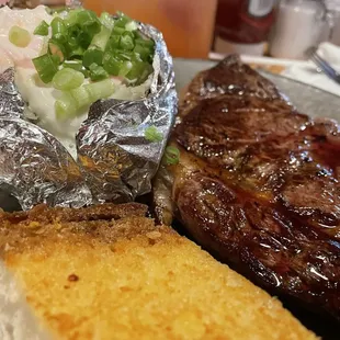 Rib Eye Steak - Medium Rare. Comes with Garlic Bread, Salad &amp; Baked Potato.
