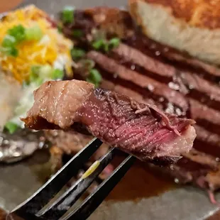 Rib Eye with a Baked Potato and Green Salad (not pictured). Comes with Garlic Bread too!