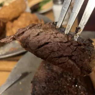 a steak being cut with a fork