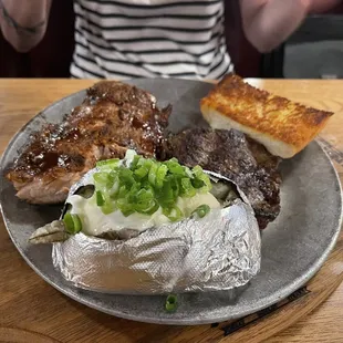 Steak and ribs with baked potato and salad (not shown)
