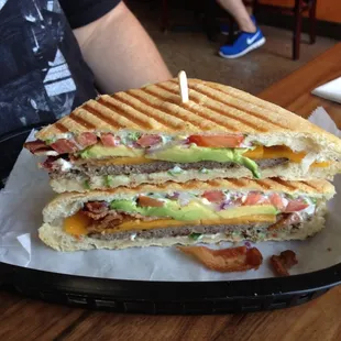 The new Bur-Gini, a blend of chuck, short rib, and brisket with bacon, avocado, roasted garlic, tomato, jalapeño cream cheese.
