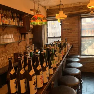 a row of wine bottles on a bar