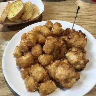 a plate of tater tots and a plate of breaded potatoes