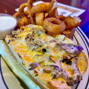 Philly cheesesteak sandwich with onion rings